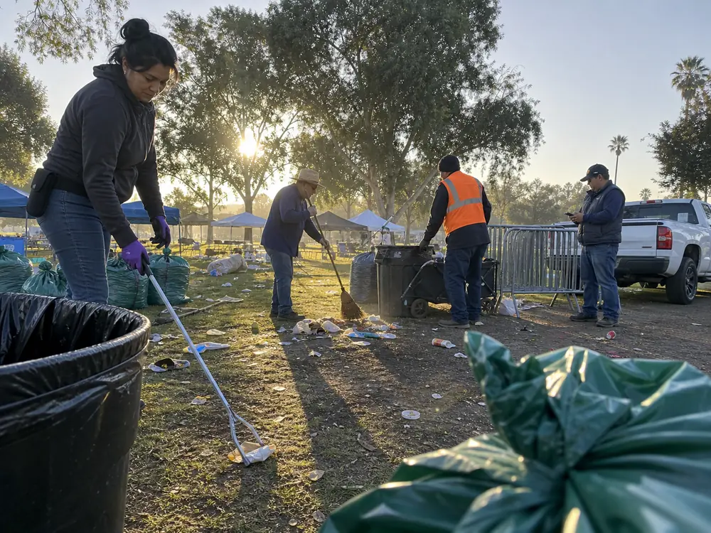 Crew cleaning a park path after an outdoor event
